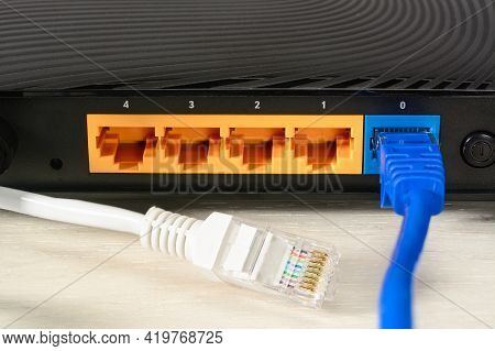 Home Wi-fi Router For Internet Connection With Two Patch Cords With Rj45. Concept Home Network, Clos