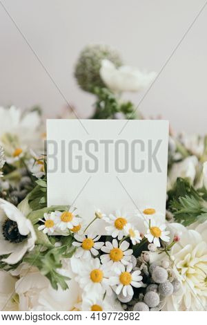 Bouquet of white flowers with a blank card