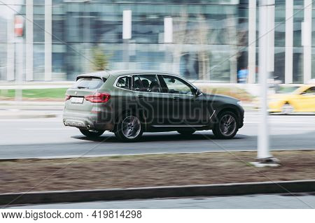 Fast Moving Bmw X3 G01 On The City Road. Green Suv With Man Driving. Premium Auto In Fast Motion Wit
