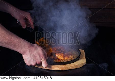 Fajitos, Meat In A Frying Pan With Fire On A Wooden Tray, Beautiful Serving, Dark Background.