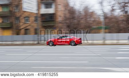 Red Aggressive Bmw Sport Car Riding On The Road. Side View Of Shiny Bmw M4 F82 Driving In The Street