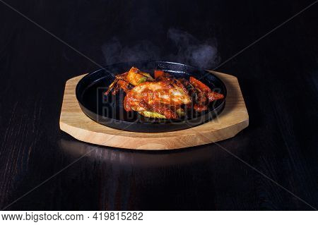 Fajitos, Meat In A Frying Pan With Fire On A Wooden Tray, Beautiful Serving, Dark Background.