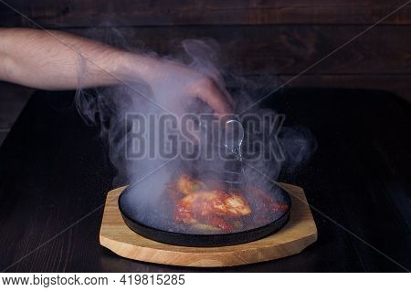 Fajitos, Meat In A Frying Pan With Fire On A Wooden Tray, Beautiful Serving, Dark Background.