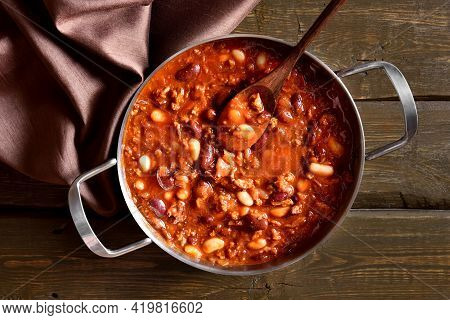 Cowboy Beans With Ground Beef, Jalapeno Pepper And Bacon In Cooking Pan Over Wooden Background. Top 