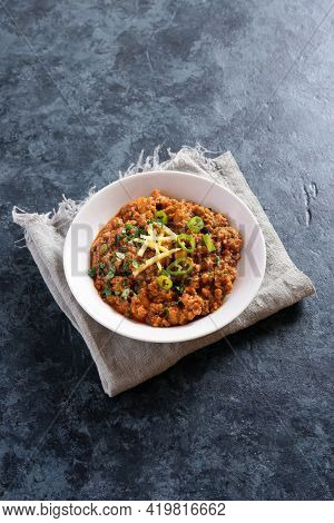 Keema Curry In Bowl Over Blue Stone Background With Free Text Space. Indian And Pakistani Style Dish
