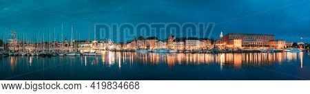 Stockholm, Sweden. Scenic Famous View Of Embankment In Old Town Of Stockholm In Night Lights. Gamla 