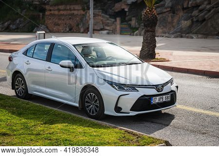Alanya, Turkey - April 17 2021: White  Toyota  Corolla Is Parked  On The Street On A Warm Summer Day