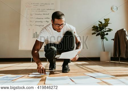 Businessman planning a marketing strategy on a wooden floor