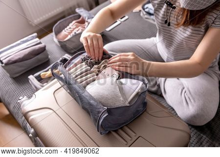 Unidentified Woman Packing Lingerie Into Storage Case Use Konmari Method Getting Ready To Vacation