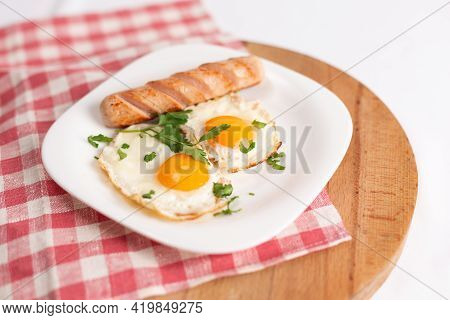 Filipino Silog Breakfast With Garlic Fried Rice, Longsilog, And Two Sunny Side Up Eggs