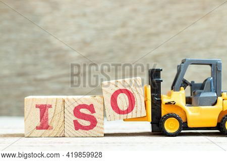 Toy Forklift Hold Letter Block O To Complete Word Iso On Wood Background
