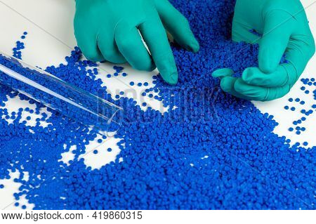 Plastic Beads On Green Gloved Hand. Polymer Beads. The World\'s Plastic Reduction Policy. Plastic On