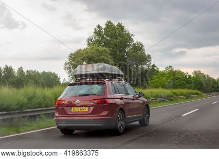 Godollo, Hungary. June 16, 2020. Red Volkswagen Tiguan Car With Gray Roof Luggage Box Driving On The