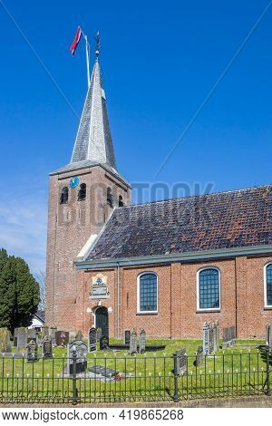 Warten, Netherlands - April 27, 2021: Tower Of The Historic Church In Warten Village, Netherlands