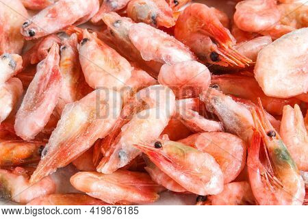 Close-up Of A Pile Of Frozen Shrimps. No Cleaned Shrimp, Prawns Not Peeled. Natural Seafood Backgrou