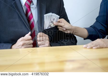 Businessmen Or Customers Are Putting Money Into The Pocket