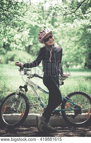 Konstantinovka, Ukraine - May 08, 2021: Little Girl Posing With A Bicycle. Warm Sunny Summer Day In 