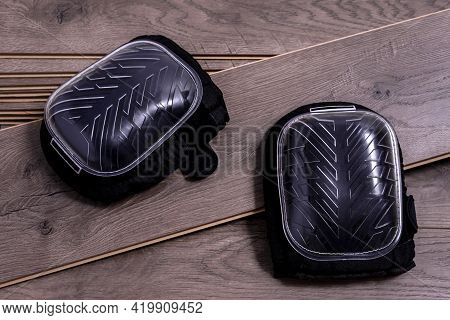 A Pair Of Knee Protectors Or Knee Pads For Work On Planks Of Laminate Floor. Selective Focus.