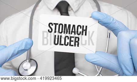 Doctor Holding A Card With Stomach Ulcer, Medical Concept