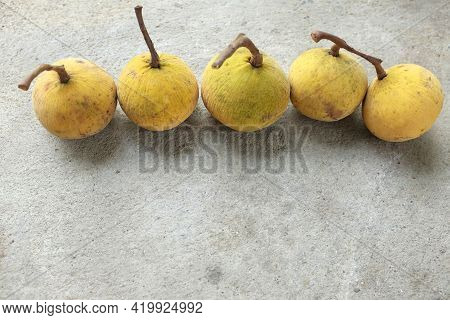 Flat Lay Fresh Ripe Santol Or Sentul Fruit (sandoricum Koetjape) Isolated On On Cement Floor Backgro