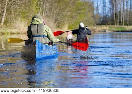 Family Canoeing On The River In The Early Morning. Joint Pastime, Entertainment, Outdoor Recreation,