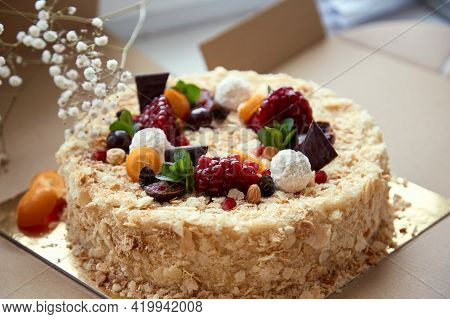 Birthday Cake Decorated With Fruit, Pomegranate Seeds, Chocolae And Grapes In He Box. Top View. High