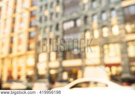 Abstract Blurred Building With Illuminated Facade Exterior At The Sunset. Blurry Modern Building Wit