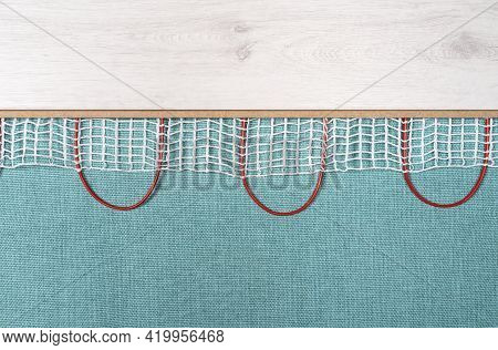 Heated Floor Under Laminate Background. Underfloor Electric Heating. Warm Floor System Texture. Mat