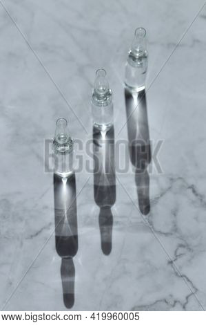 Mesotherapy Serum. Transparent Cosmetic Ampoules On A Marble Background.beauty And Skin Care Concept
