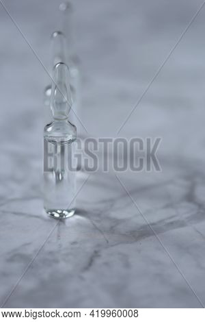 Mesotherapy Serum. Transparent Cosmetic Ampoules On A Marble Background.beauty Concept