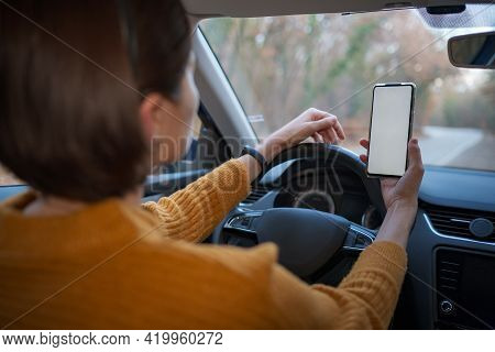 Mockup Image Of A Woman Holding And Using Mobile Phone