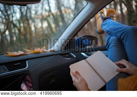 Woman Feet On Car Door. Feet Outside The Window At Sunset Forest