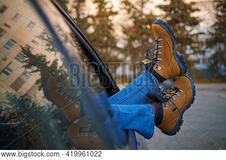 Woman Feet On Car Door. Feet Outside The Window At Sunset Forest