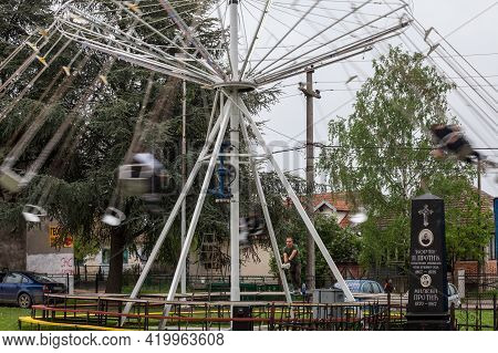 Ripanj, Serbia - May 1, 2021: Swing Ride, Or Chair O Plan, With A Selective Blur On The Employee Sta