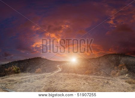 Gerakas hills burnt by wild fire at sunset
