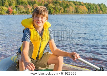 Boy In A Boat In Water