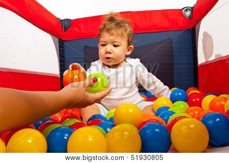 Mom Hand Giving Balls To Baby