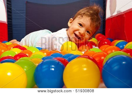 Happy Baby Laying On Balls