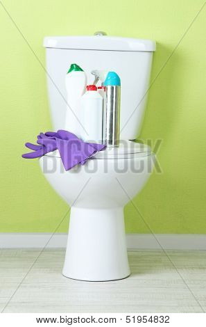 White toilet bowl and cleaner bottle in a bathroom