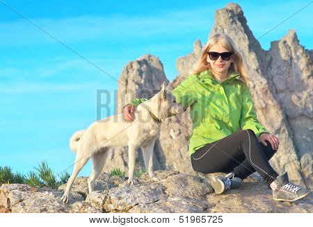 Smiling Woman Traveler And White Dog Sitting On Stones Relaxing With Rocky Mountain Peak Ai-petri An