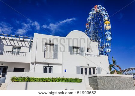 ferry wheel under bright blue sky