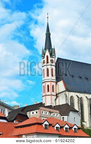 Turrent Of The Church, Roofs And Houses Against The Blue Sky