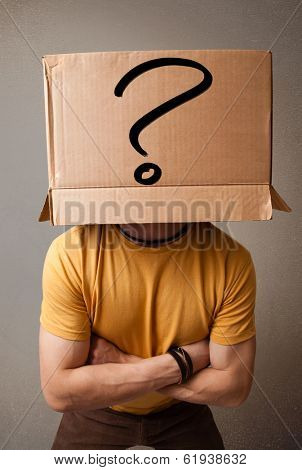 Young man standing and gesturing with a cardboard box on his head with question mark