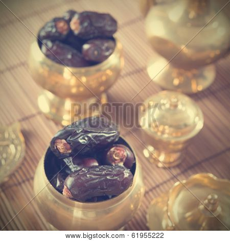 Dried date palm fruits or kurma, ramadan food which eaten in fasting month in retro effect.