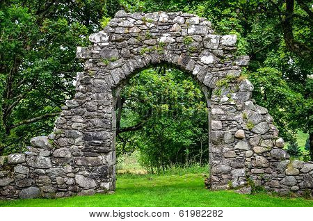 Old Stone Entrance Wall In Green Garden