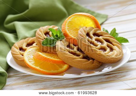 mini dessert tarts with orange on wooden table