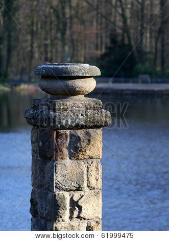 Statue Standing In The Pakr Near The Lake