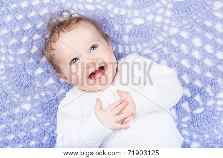 Happy Laughing Baby On A Purple Hamdmade Knitted Blanket