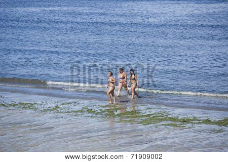 BAIONA, GALICIA, SPAIN - AUGUST 30: girls at the beach, on August 30, 2014 in Baiona, Galicia, Spain.