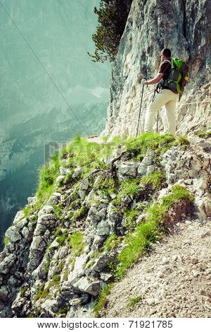 Young Man Backpacker Walking On Mountain Trail Cinque Torri, Cortina D'ampezzo, The Dolomites Mounta